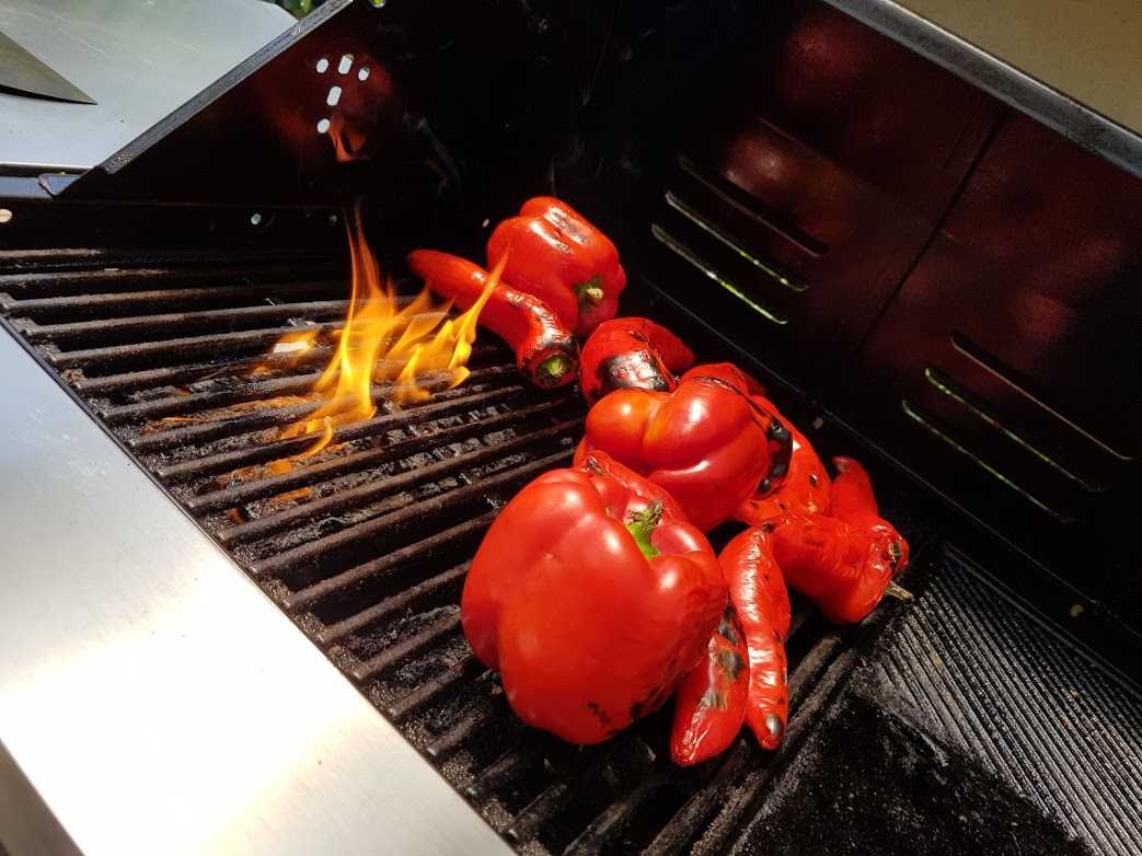 red capsicums on barbeque with fire