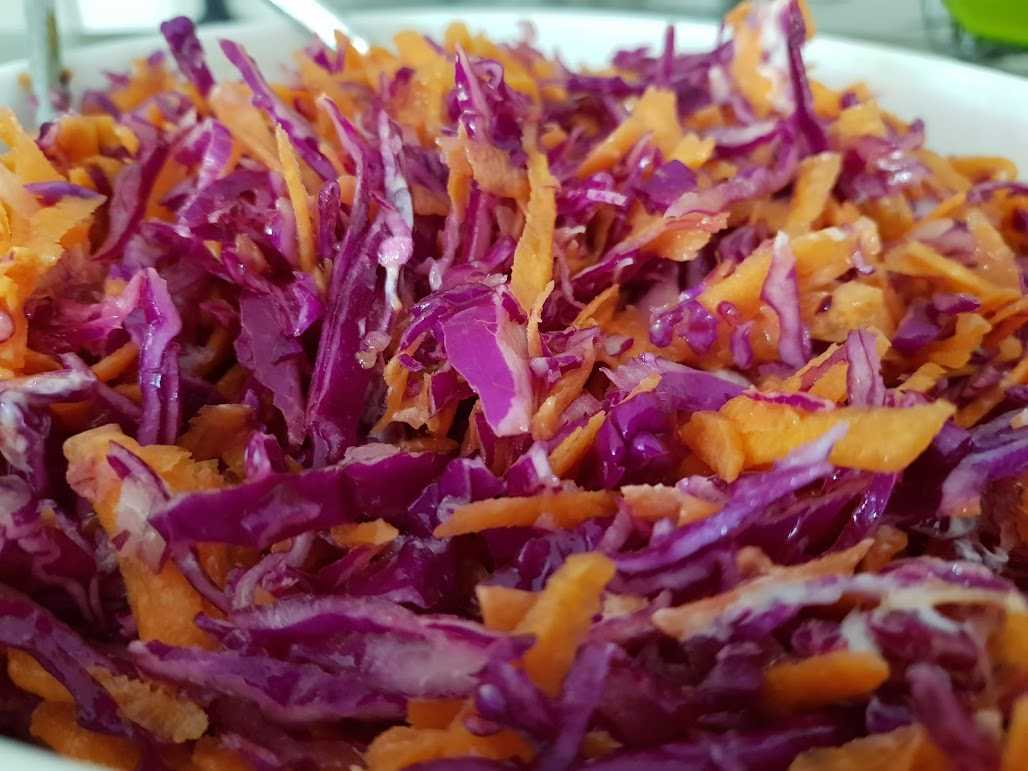 Coleslaw with cabbage, carrot, red onion, lemon juice, mayonnaise, vinegar, oil and salt